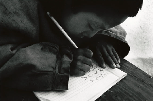 indigenous boy writing syllabics